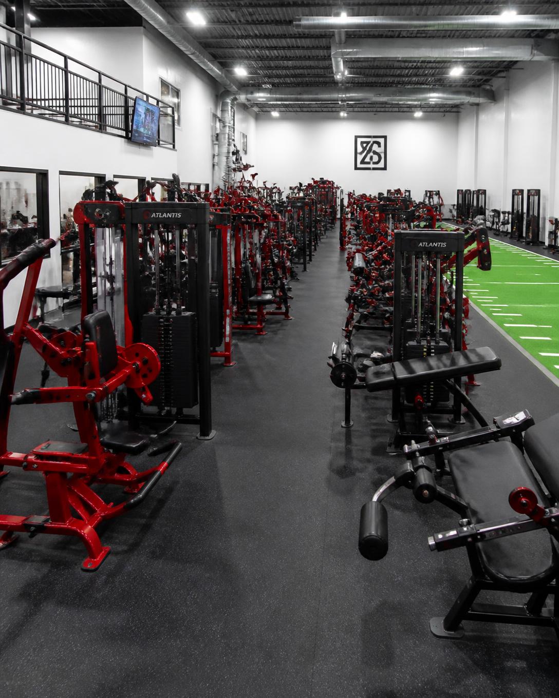 A long aisle of closely spaced strength machines at Redwood Fitness