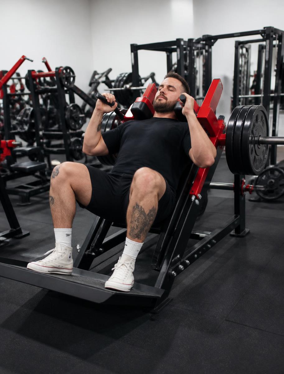 A member training heavy on a plate-loaded machine